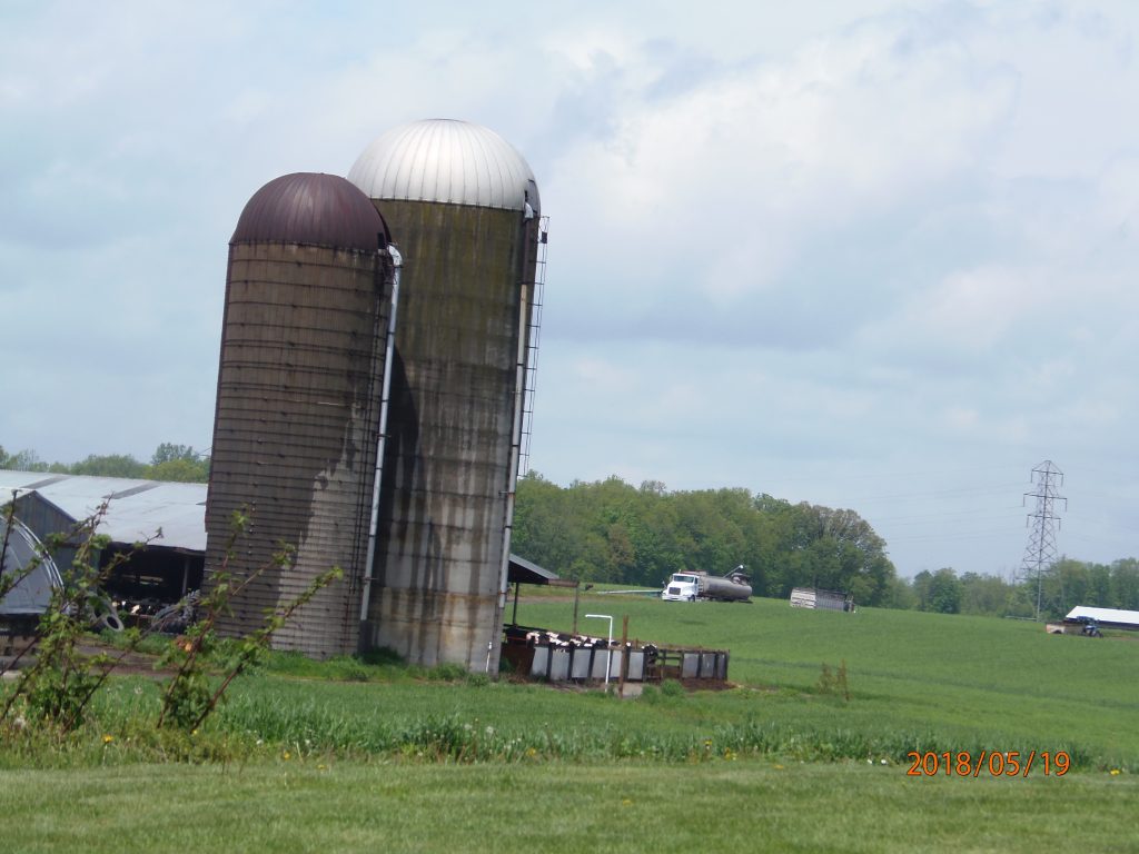 May 19, 2018 – Terrehaven pen (behind silos). Fence panels missing, manure piling up outside of containment area, just before the corner of the pen. This CAFO has been under a Consent Order since Nov. 6, 2013. C’mon now, enough is enough.